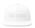 A white structured baseball cap with a flat brim, featuring the text 'blk crown' in a raised, gothic-style font on the front panel, set against a plain white background.