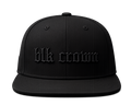 A black flat-brim snapback cap with 'blk crown' embroidered in a matching black gothic font on the front, shown against a solid white background.