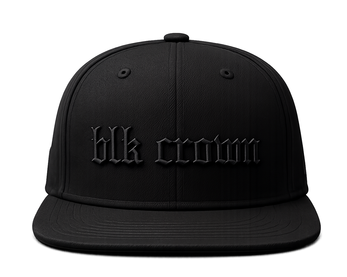 A black flat-brim snapback cap with 'blk crown' embroidered in a matching black gothic font on the front, shown against a solid white background.