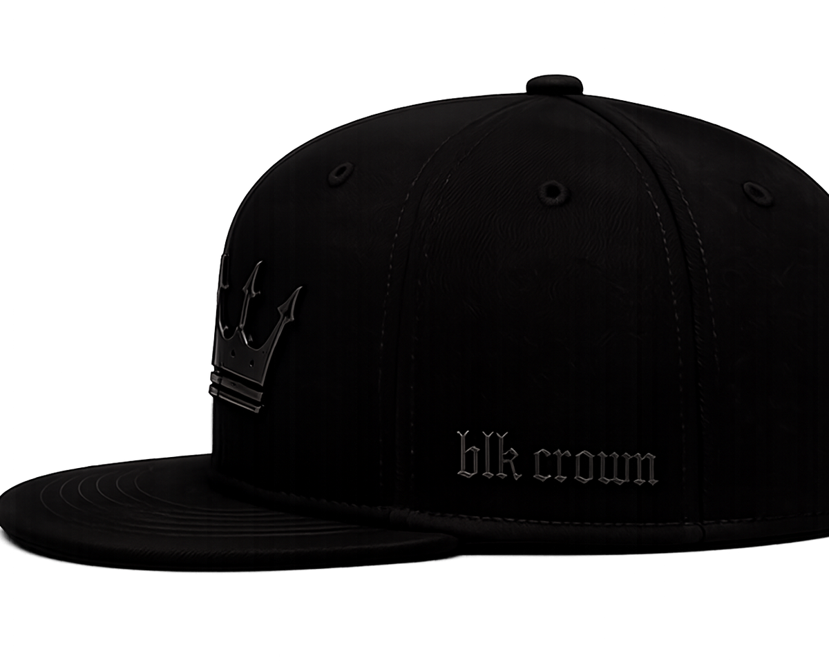 A black flat-brim snapback cap with a tonal black crown embroidery featuring a crown graphic and the text 'blk crown' on the side, shown against a plain white background.
